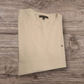 T-shirt Tommy Hilfiger in cotone beige a girocollo con logo ricamato, proposta da Ottoman Kumus